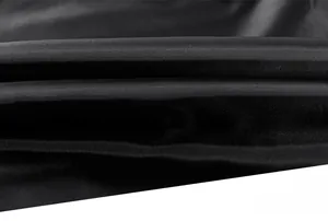 Macro detail of the smooth black inner lining fabric of the men's casual jacket