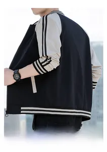 Detail view of the back of a men's black and beige color-block baseball jacket with stripes