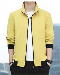 Detail of yellow casual jacket showing stand collar, black ribbed cuffs and metal zipper