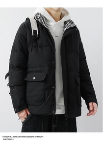 Detail of men's black winter coat with waffle texture fabric and large utility pockets