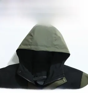 Detail display of the hooded neckline with metal snaps and black zipper on this windbreaker jacket