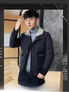Close-up of black quilted winter jacket with warm beige shearling collar and metal snaps