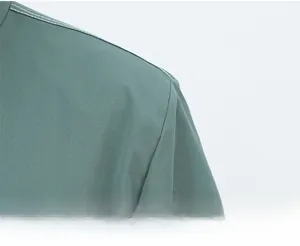 Detail of gray-green work jacket shoulder with precise white contrast stitching