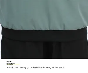Detail of the black elastic ribbed hem on a casual work jacket in pea green color