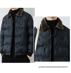 Detail view of navy blue winter puffer jacket with brown fur collar and brand badge