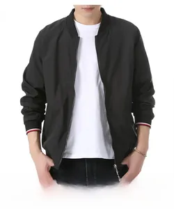 Detail of black baseball jacket featuring red and white striped ribbed cuffs on the sleeves