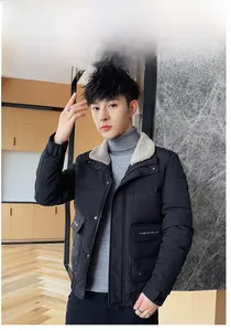Detail of men's winter jacket showing beige faux fur collar and black quilted fabric