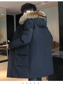 Close-up of black winter parka featuring large utility pockets and fluffy fur collar