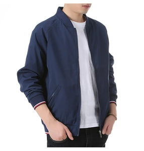 Detail of navy blue bomber jacket showing striped ribbed cuffs and waistband trim