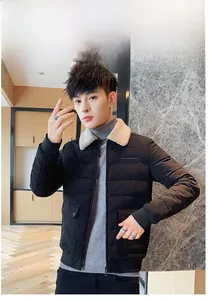 Close-up of men's black quilted jacket with beige faux shearling collar and utility pockets