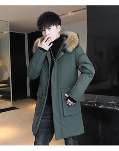Detail view of premium dark green parka with oversized natural fur hood and functional pockets
