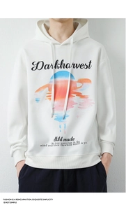 Détail d'un sweat à capuche blanc avec graphique de coucher de soleil et lettrage rétro
