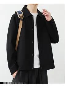 Close-up detail of black waffle-textured men's jacket showing lapel collar and matte buttons