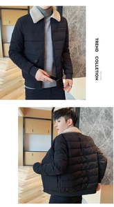 Close-up detail of black quilted jacket with cream faux shearling collar and flap pockets