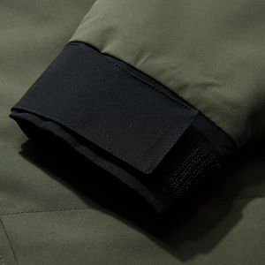 Men's olive green windbreaker jacket featuring adjustable velcro cuffs and windproof fabric