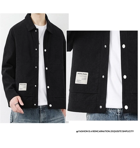 Detail of black corduroy jacket fabric with white contrast buttons and woven brand label