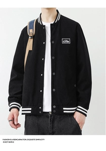 Detailed close-up of a men's black corduroy jacket with striped ribbed collar and cuffs