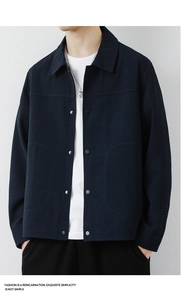 Detailed close-up of navy blue men's jacket showing rich waffle texture and metallic snaps