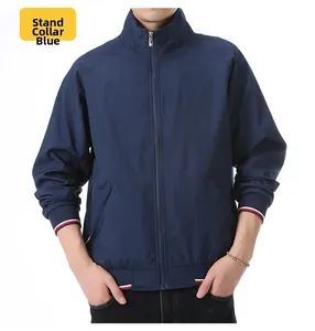 Detail of blue bomber jacket with red white blue striped ribbed cuffs and hem
