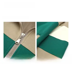 Detail of color-block zip-up jacket with forest green, khaki, and metallic zipper focus