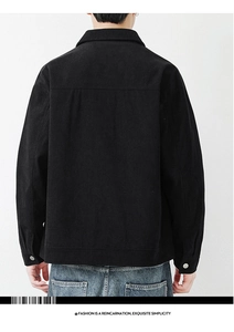 Detail view of black corduroy jacket with silver metal buttons and drop shoulder design