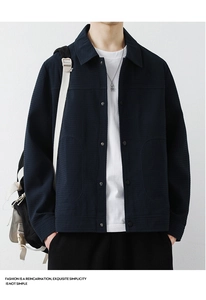 Detail of navy waffle textured jacket featuring a classic collar and button-up closure