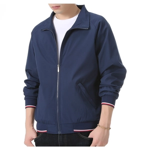 Detail of navy blue men jacket showing ribbed elastic cuffs with red and white stripe accents