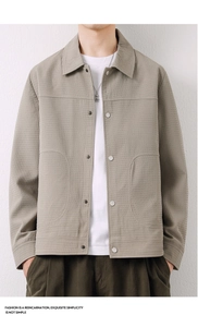 Detail of khaki waffle-knit men jacket featuring classic collar and button closure