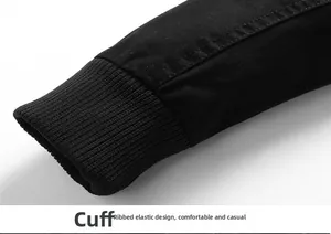 Detail of black outdoor jacket featuring elastic ribbed cuffs and durable twill fabric