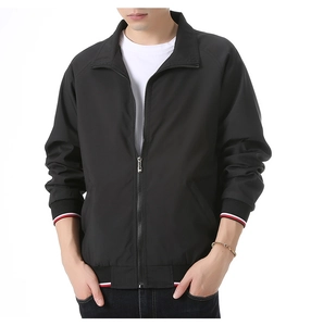 Detail of black sports jacket featuring striped ribbed cuffs and high-quality metal zipper
