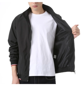 Close-up detail of the inner pocket and striped ribbed cuff on this black bomber jacket