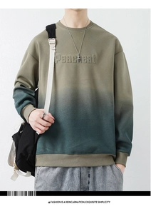 Detailed close-up of 3D embossed Peachcat lettering on a green gradient cotton sweatshirt