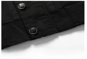 Detail of multi-stitched hem on black cotton work jacket with matte buttons and ribbing