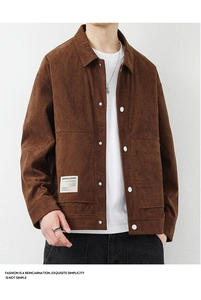 Close-up of caramel corduroy jacket collar with branded label and white button details