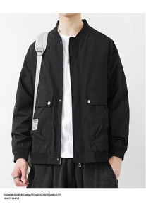 Detail of black bomber jacket featuring tactical utility pockets and a standing collar
