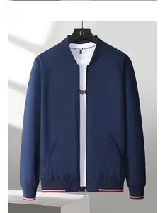 Detail of navy baseball jacket featuring striped ribbed cuffs and metal zipper closure