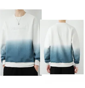 Detail of blue gradient sweatshirt featuring 3D embossed lettering and ribbed cuffs
