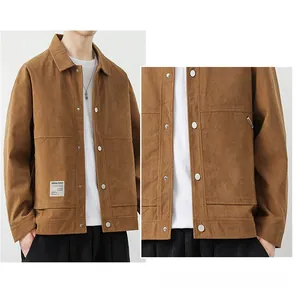 Detail of khaki corduroy jacket showing vertical texture, metal buttons and utility pockets