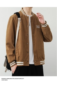 Macro shot of brown corduroy bomber jacket with ribbed collar and mountain patch