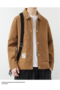 Close-up of caramel corduroy jacket featuring utility pockets and metallic buttons