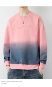 Detail of Peacheat 3D embossed lettering on a pink and blue gradient crewneck sweatshirt