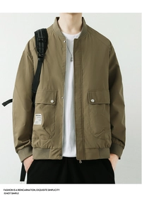 Detailed close-up of khaki green bomber jacket with ribbed collar and utility flap pockets