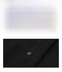 Detail of black corduroy jacket showing embroidered mountain patch and snap button pocket