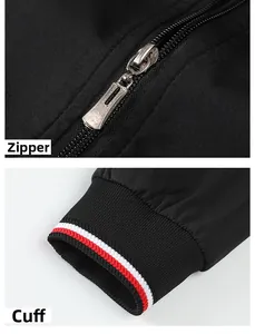 Macro detail of silver metal zipper and red-white striped ribbed cuffs on black jacket