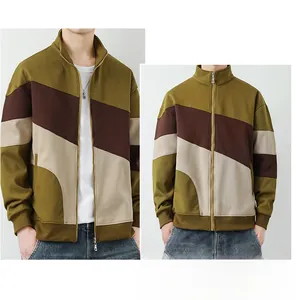 Detail of color-block zip-up jacket with olive green and brown panels and stand collar
