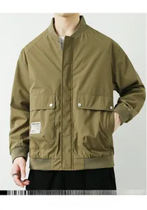 Detail of army green bomber jacket featuring dual flap pockets and woven logo patch