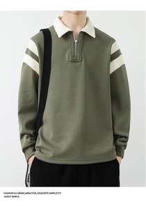 Detail of olive green sweatshirt showing half-zip lapel and cream white striped collar texture