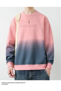 Detail of 3D embossed Peacheat text on a pink to grey gradient crewneck sweatshirt