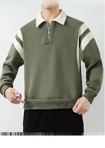 Detail of men's olive green quarter-zip sweatshirt with white contrast stripes and rib cuffs