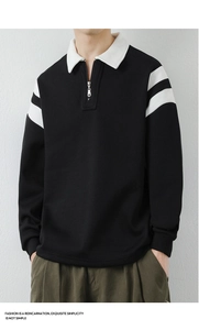 Detail of men's black sweatshirt with white collar, metal zipper, and sleeve stripes